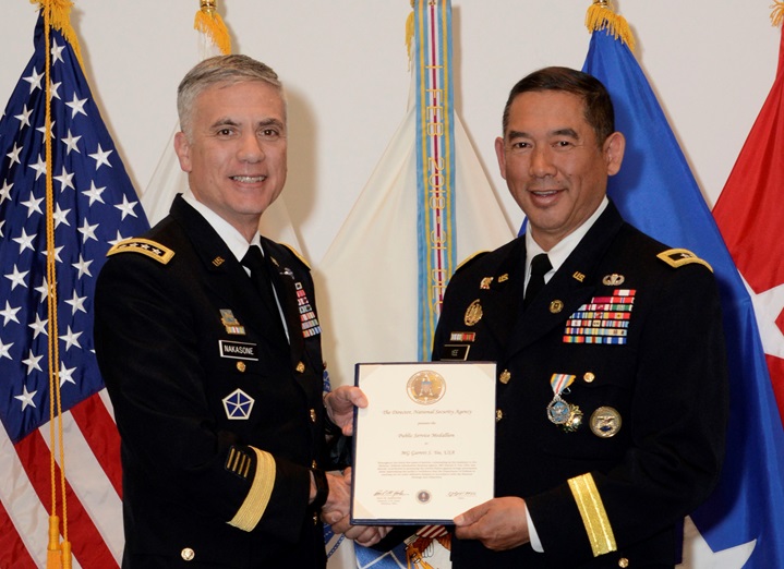 Army Gen. Paul Nakasone poses with Army Major Gen. Garrett Yee during Yee’s retirement ceremony