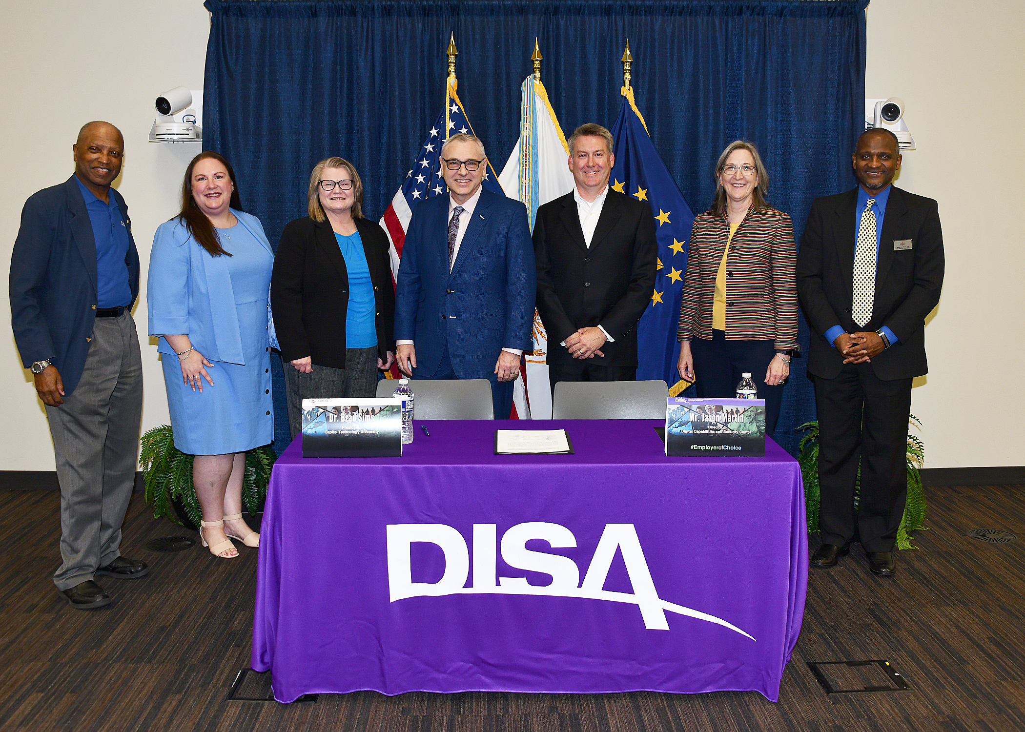 Representatives from DISA and Capitol Technology University pose for a signing ceremony photo June 24 at Fort George G. Meade. (U.S. DOD photo by Thomas L. Burton, DISA/Released).